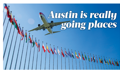 Airplane over flags at Austin Bergstrom airport