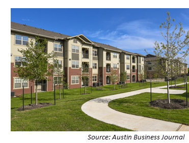 Light tan and brown multistory apartment building 