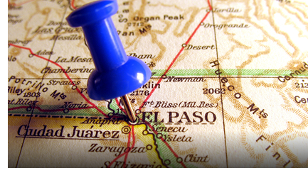 A pin sticking out of the City of El Paso on a border map.