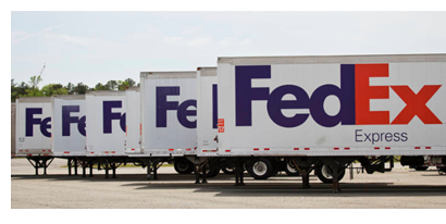 Fedex trucks line up outside distribution center