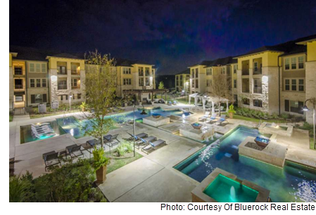 The inner courtyard of the Grand at the Dominion, showing a pool and hot tub.