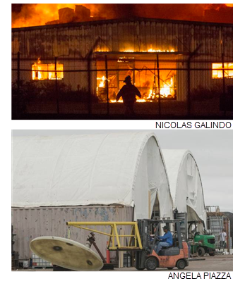 TOP: A fire fighter is silhouetted against the flames from Diamond Fiberglass on Industrial Drive. BOTTOM: Diamond Fiberglass employees work out of field tents after the warehouse burned down in July. The tents had to be taken down during Hurricane Harvey, which occurred about a week after they were set up, said Vice President Paul Cohen.